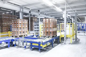 A Pallet conveying system is responsible for supplying the production lines with