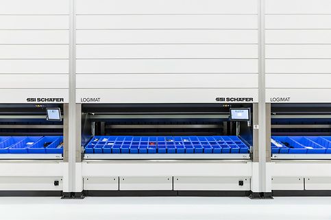 Three persons work on the six SSI LOGIMAT Vertical Lift Modules