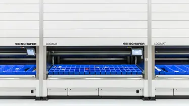 Three persons work on the six SSI LOGIMAT Vertical Lift Modules