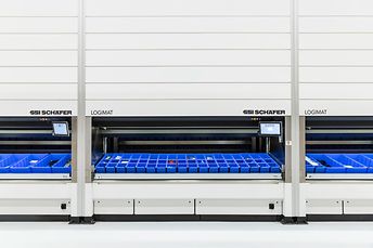 Three persons work on the six SSI LOGIMAT Vertical Lift Modules